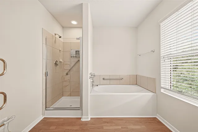 a bathroom with a bathtub and a shower