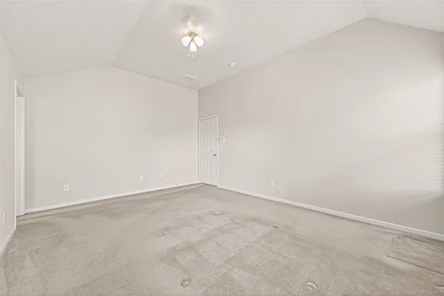 an empty room with a chandelier fan