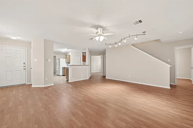 a view of a kitchen with a sink and a refrigerator