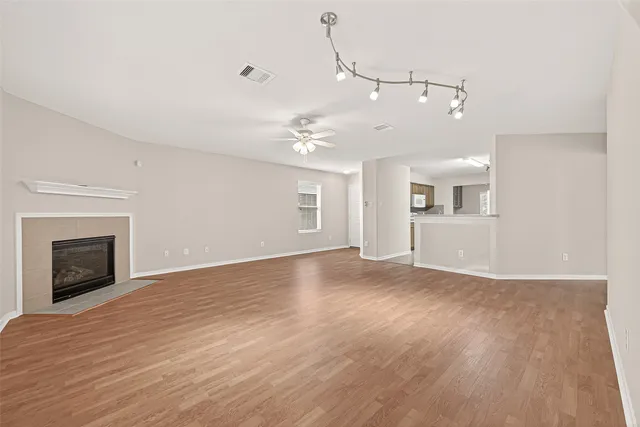 a view of an empty room with window and fire place