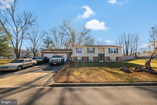 a view of a house with a yard covered with snow