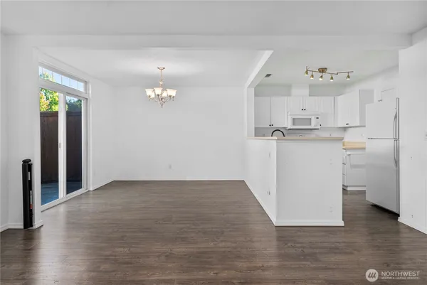 a view of a kitchen with a sink and a refrigerator