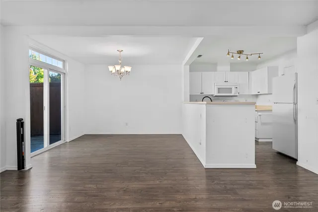 a view of a kitchen with a sink and a refrigerator