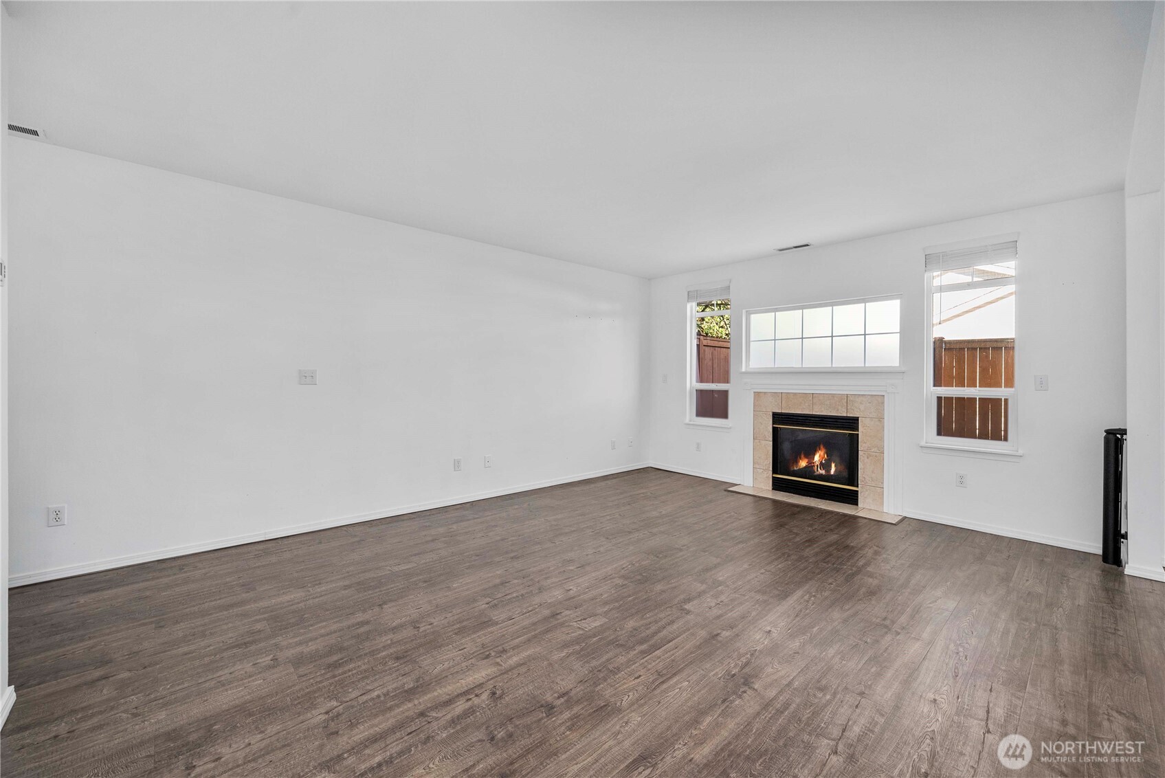 6611 Millstone Lane Southeast, Unit F101 Lacey, WA 98513 - Photo 18 of 40 an empty room with wooden floor fireplace and windows