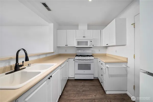 a view of white cabinets and sink