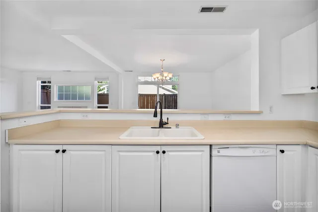 a kitchen with granite countertop a sink and cabinets