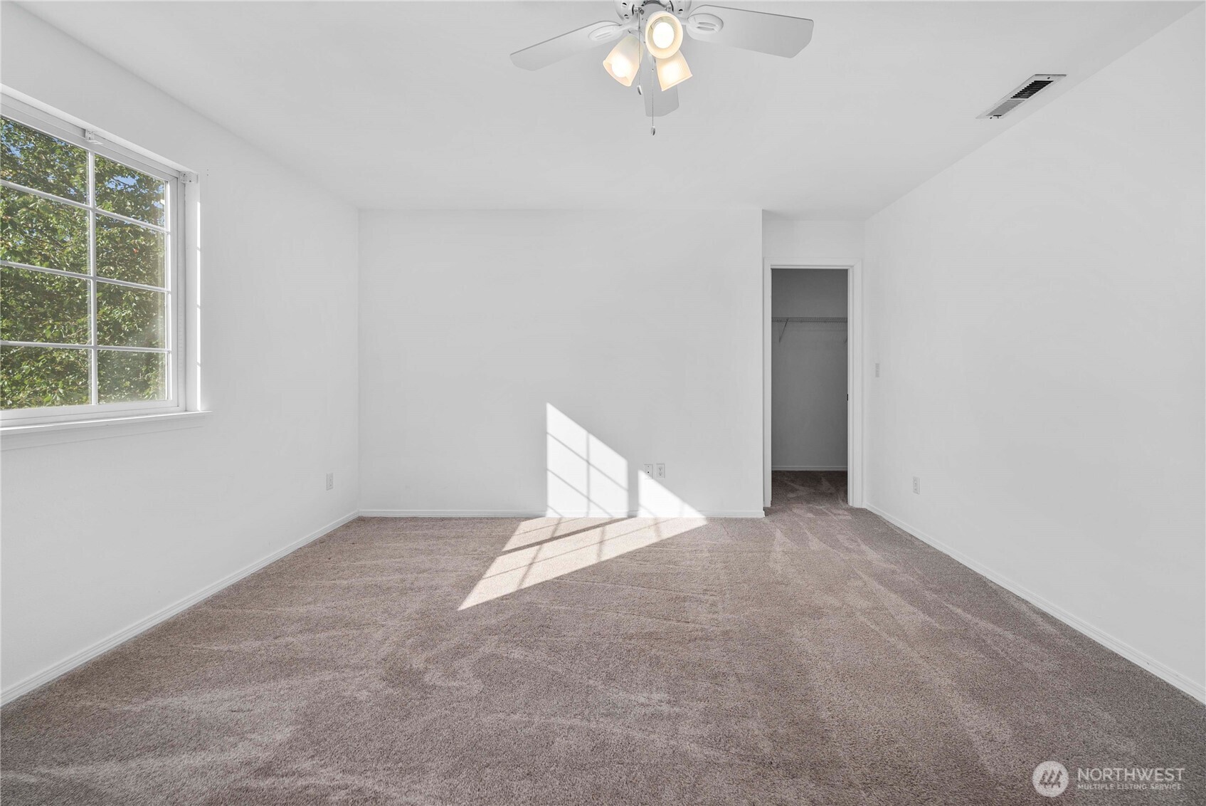 6611 Millstone Lane Southeast, Unit F101 Lacey, WA 98513 - Photo 27 of 40 an empty room with chandelier fan and windows