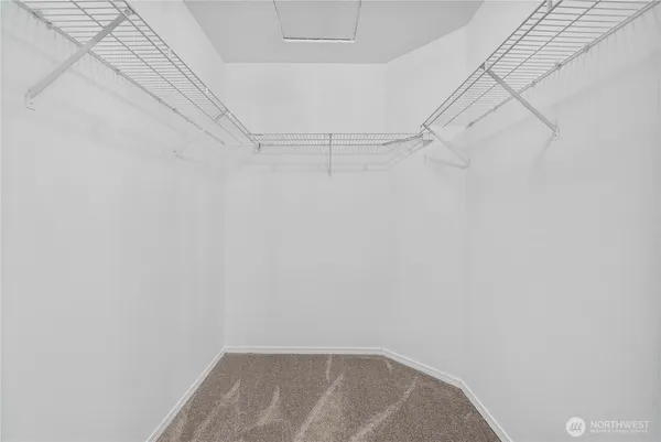 an empty room with a ceiling fan and a window