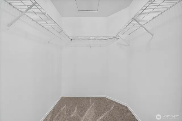 an empty room with a ceiling fan and a window