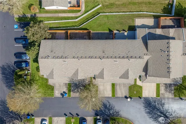 an aerial view of a house with a yard