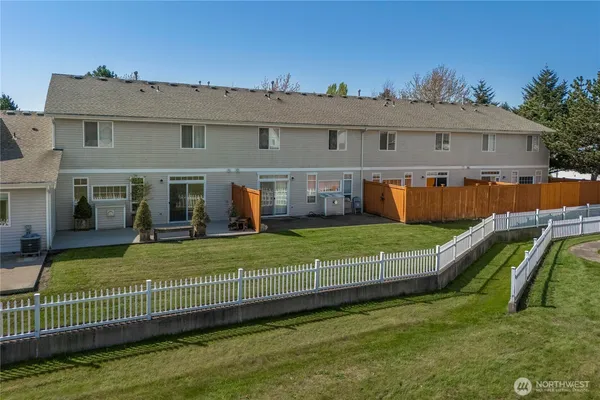 a view of a house with a backyard