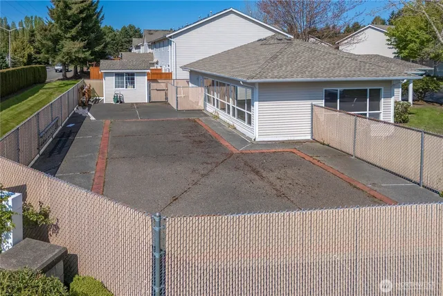 a view of a white house with a sink and dishwasher