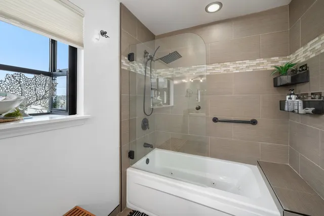 a bathroom with a bathtub and a shower