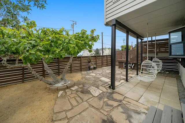 a view of a backyard with sitting area