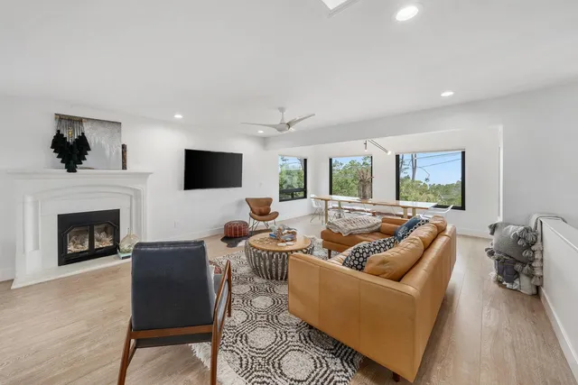 a living room with furniture a fireplace and a flat screen tv