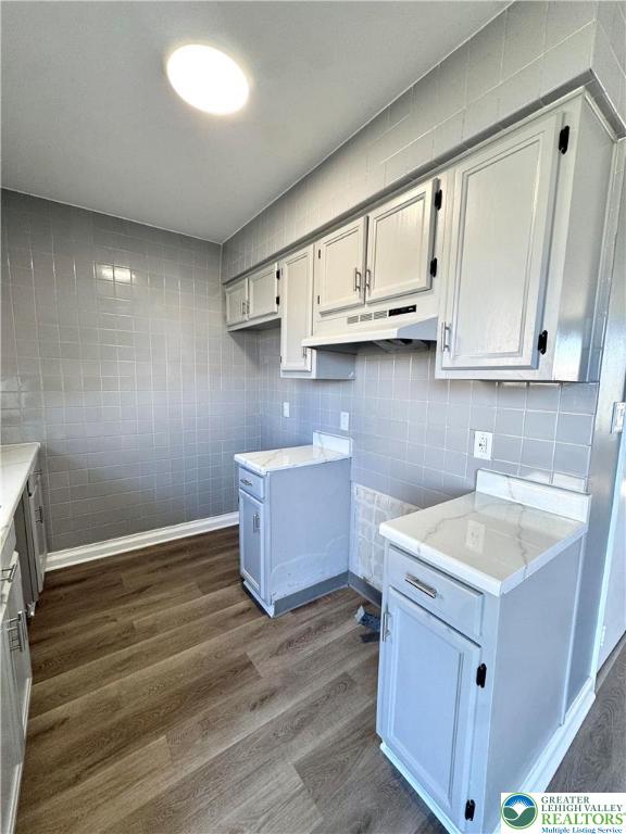1905 South Law Street Allentown, PA 18103 - Photo 4 of 18 a kitchen with stainless steel appliances granite countertop a sink stove and cabinets