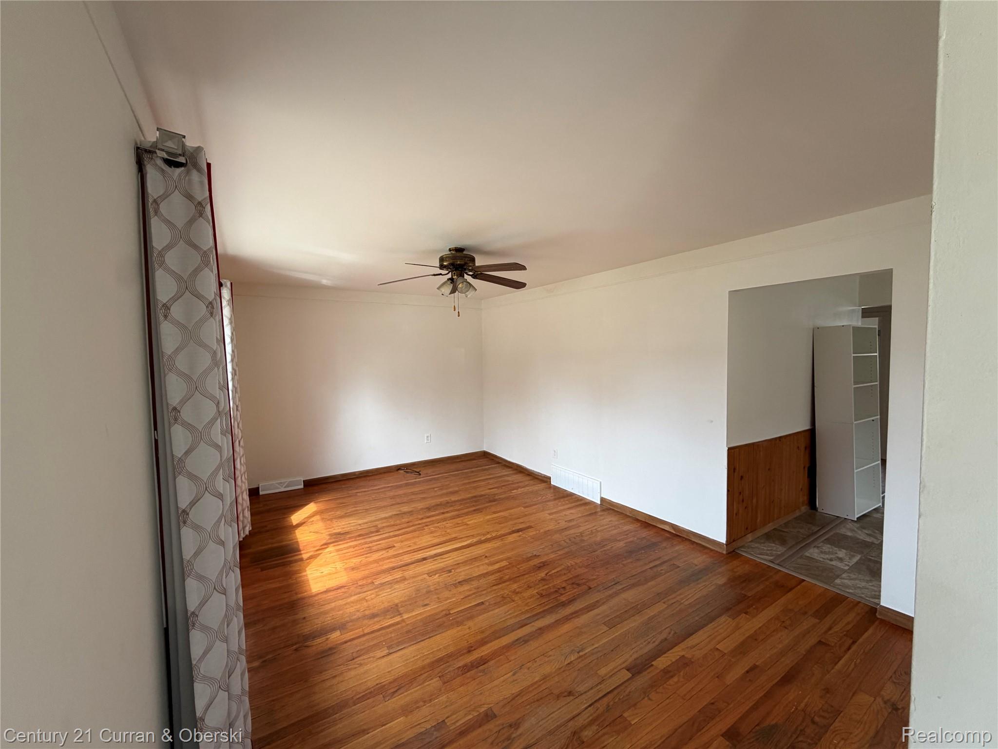 5972 North Gulley Road Dearborn Heights, MI 48127 - Photo 2 of 7 Empty room with hardwood / wood-style floors and ceiling fan