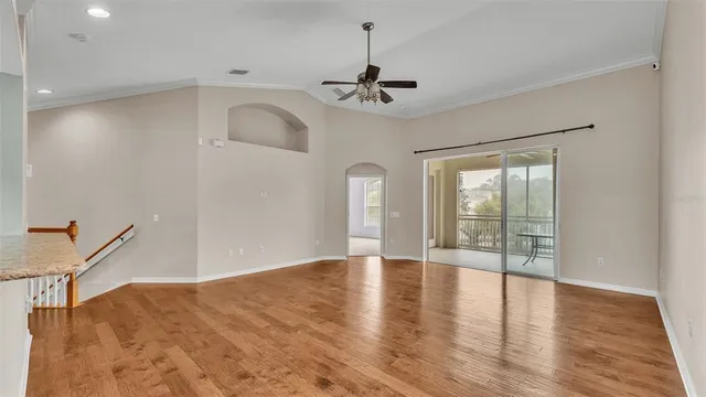 a view of a room with a window and furniture