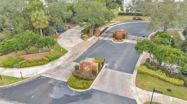 a view of a large white building with a large pool