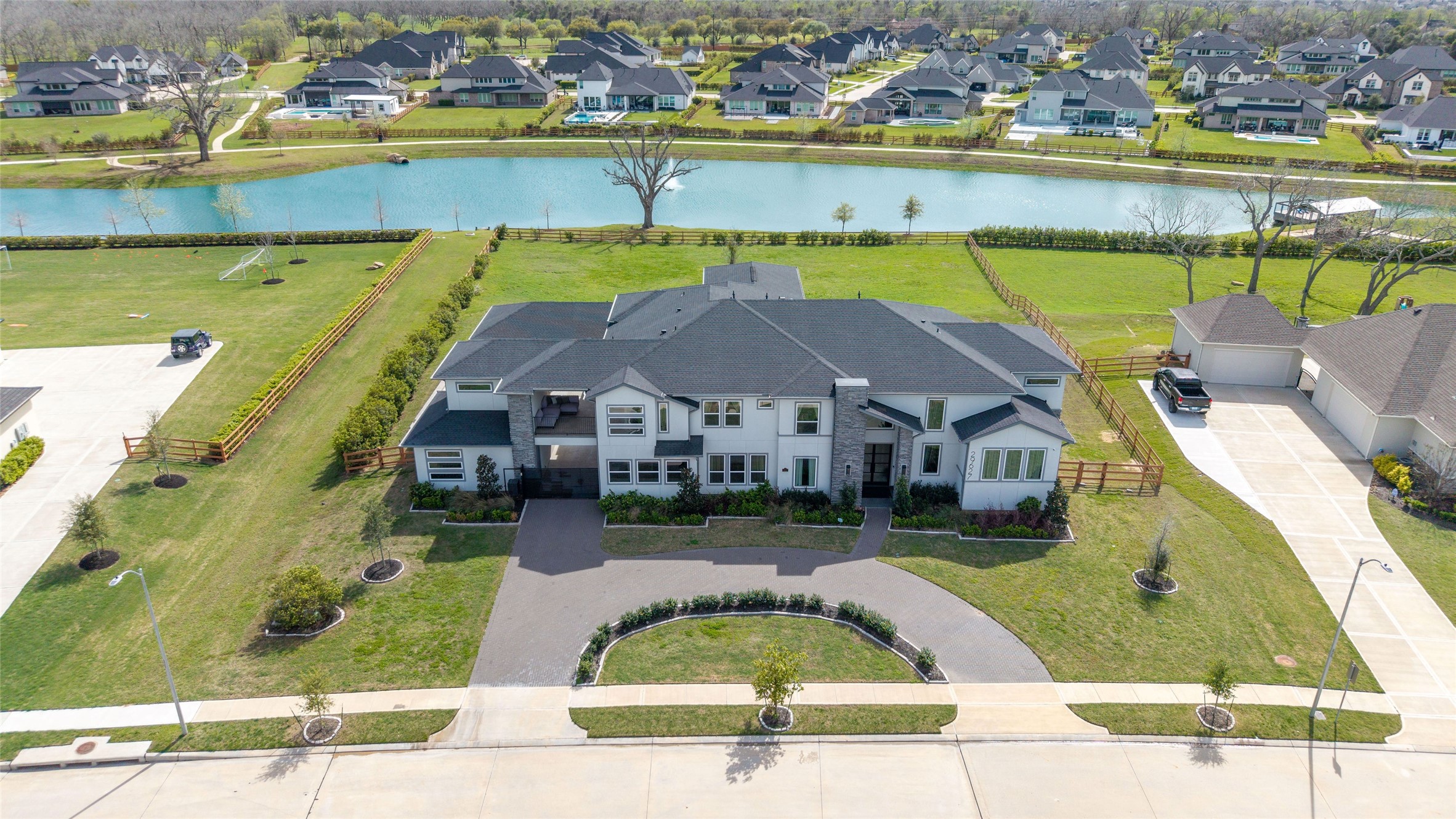 29627 Cir S Rnch Trail Fulshear, TX 77406 - Photo 49 of 50 From above, the vision becomes clear. Resort-inspired outdoor living, a private detached casita, gated motor court, and a custom estate perfectly positioned to capture sweeping lake views.