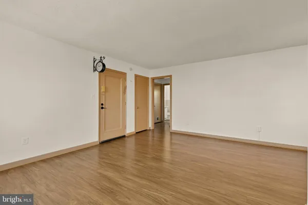 a view of an empty room and wooden floor