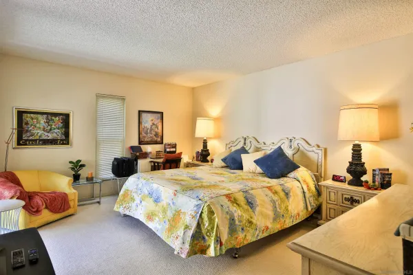 a bedroom with two beds and lamp