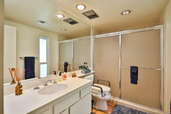 a bathroom with a sink toilet and shower