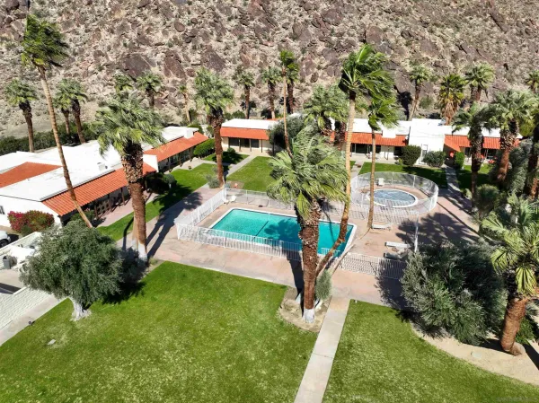 an aerial view of a house with a yard outdoor seating and lake view
