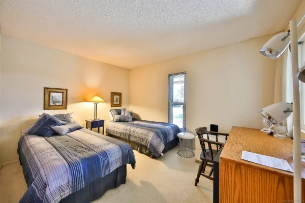 a bedroom with two beds and painted walls