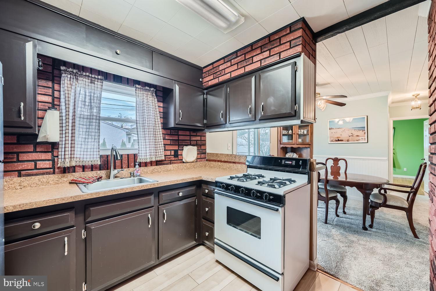 407 Brownell Road Middle River, MD 21220 - Photo 11 of 28 a kitchen with stainless steel appliances granite countertop a stove a sink and a microwave