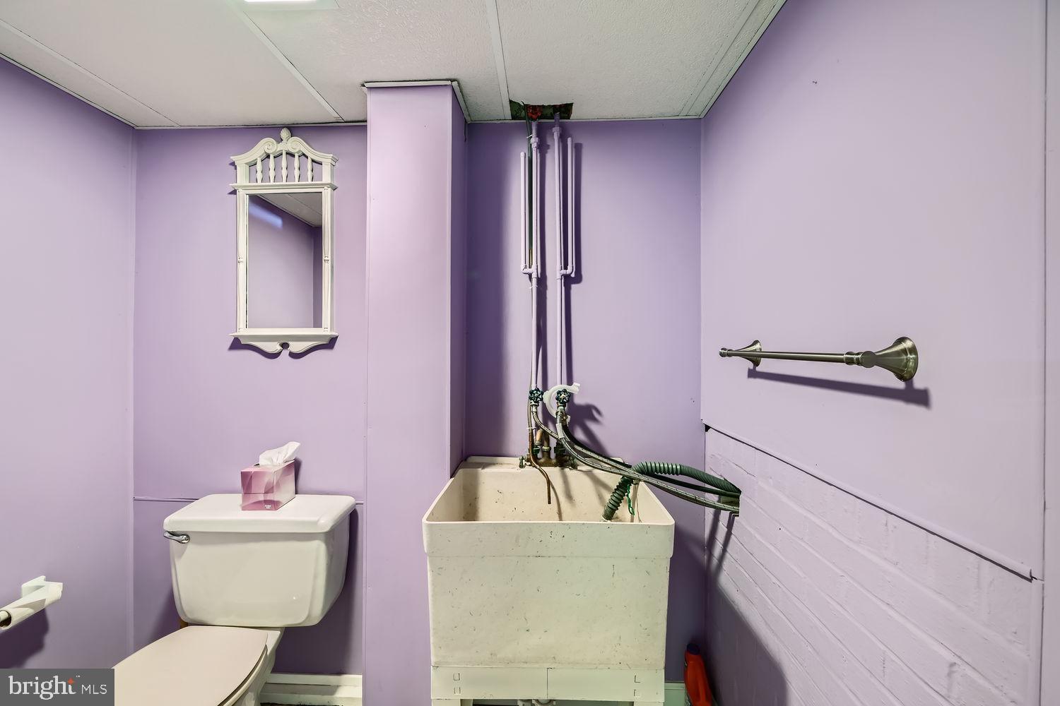 407 Brownell Road Middle River, MD 21220 - Photo 23 of 28 a bathroom with a toilet a sink and mirror