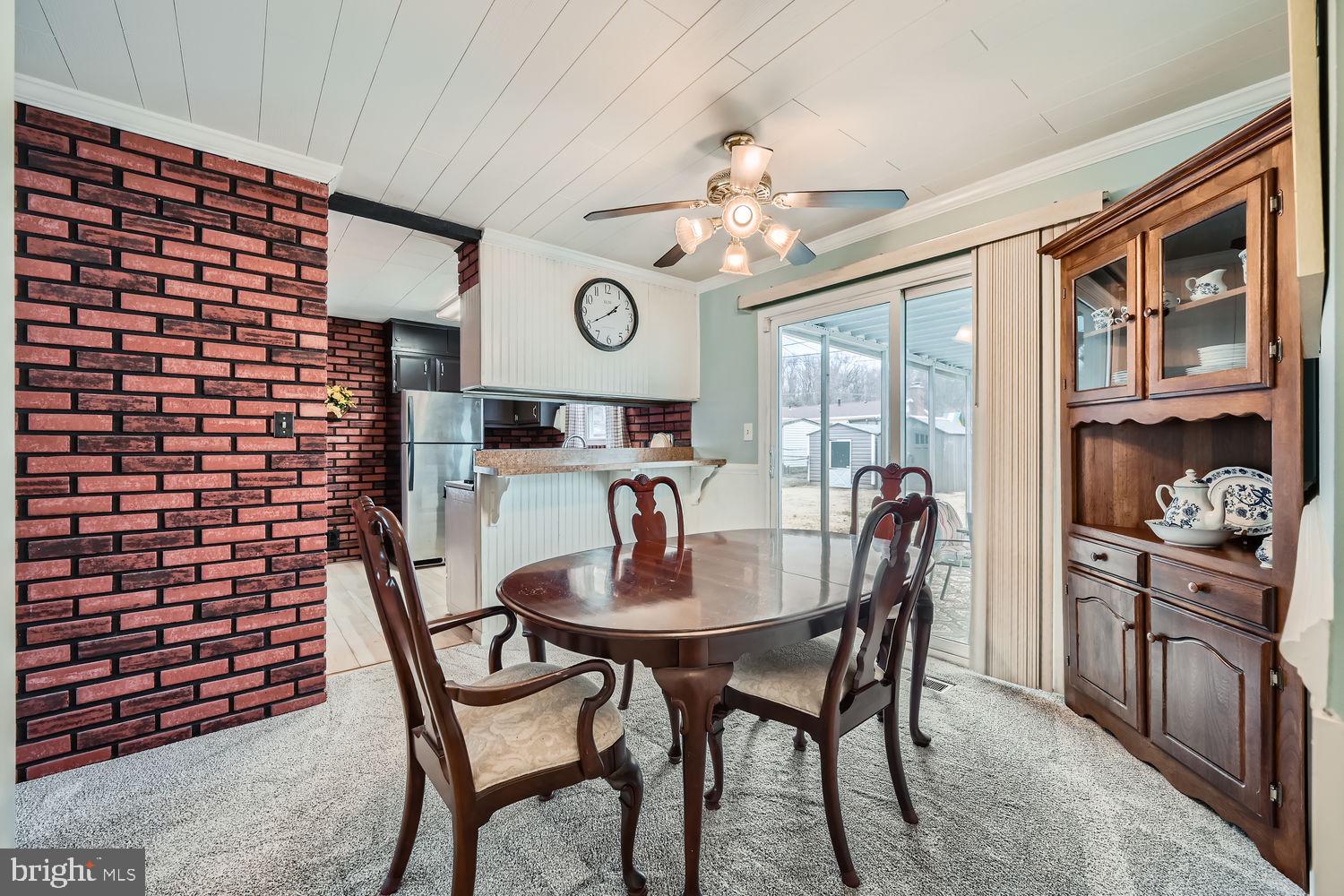 407 Brownell Road Middle River, MD 21220 - Photo 7 of 28 a view of a dining room and livingroom with furniture wooden floor and a chandelier