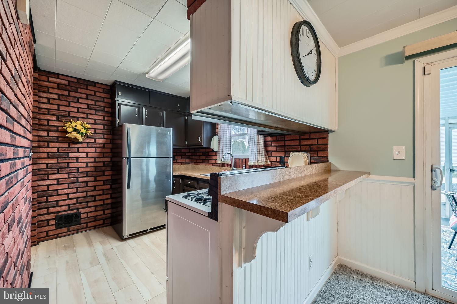 407 Brownell Road Middle River, MD 21220 - Photo 9 of 28 a kitchen view with a sink and a refrigerator