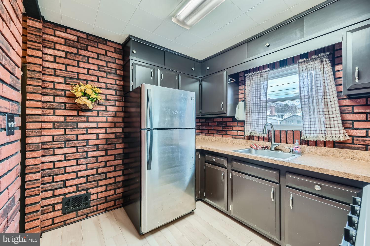 407 Brownell Road Middle River, MD 21220 - Photo 10 of 28 a kitchen with a refrigerator and a sink