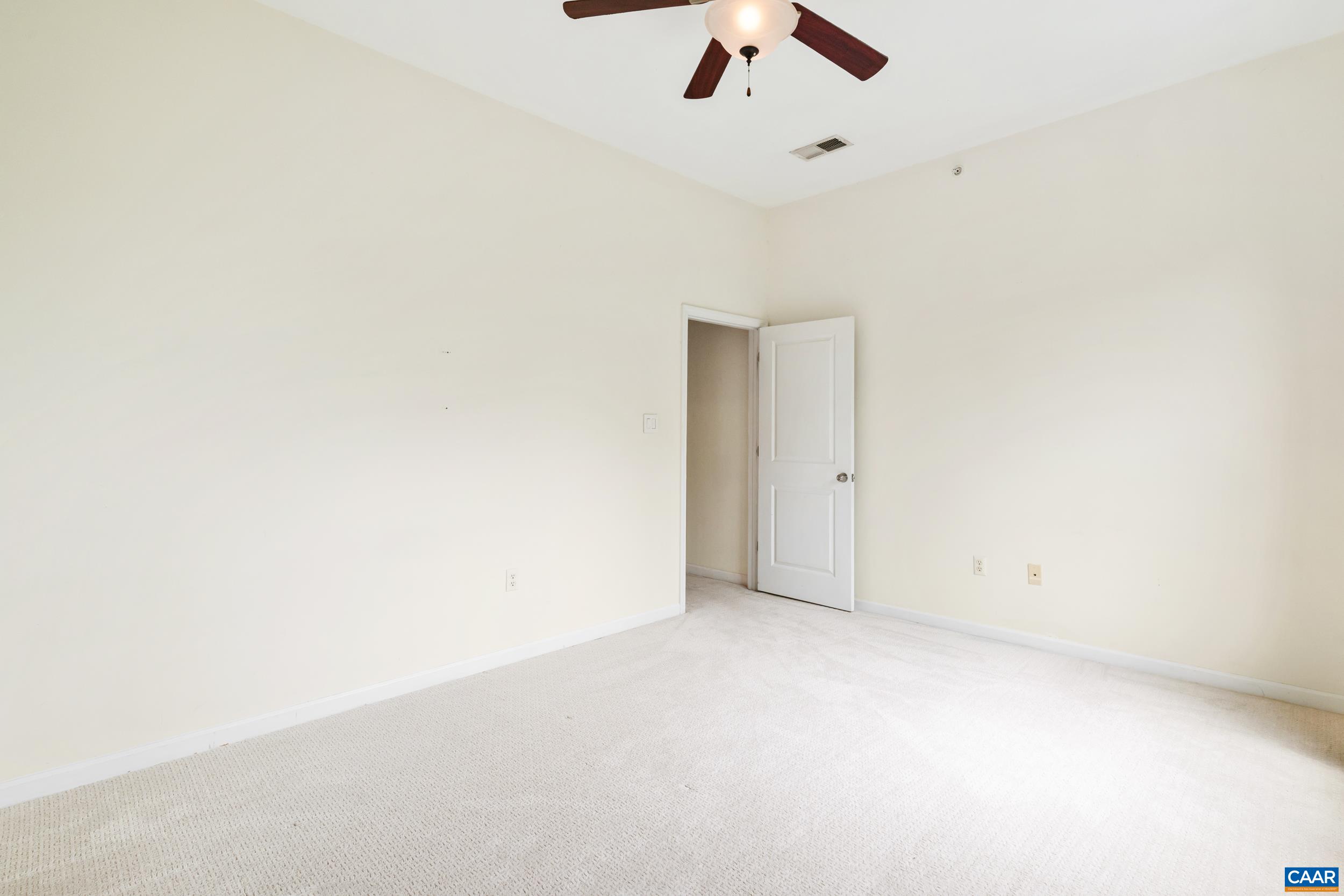 760 Walker Square, Unit 4B Charlottesville, VA 22903 - Photo 19 of 40 an empty room with a empty space and a ceiling fan