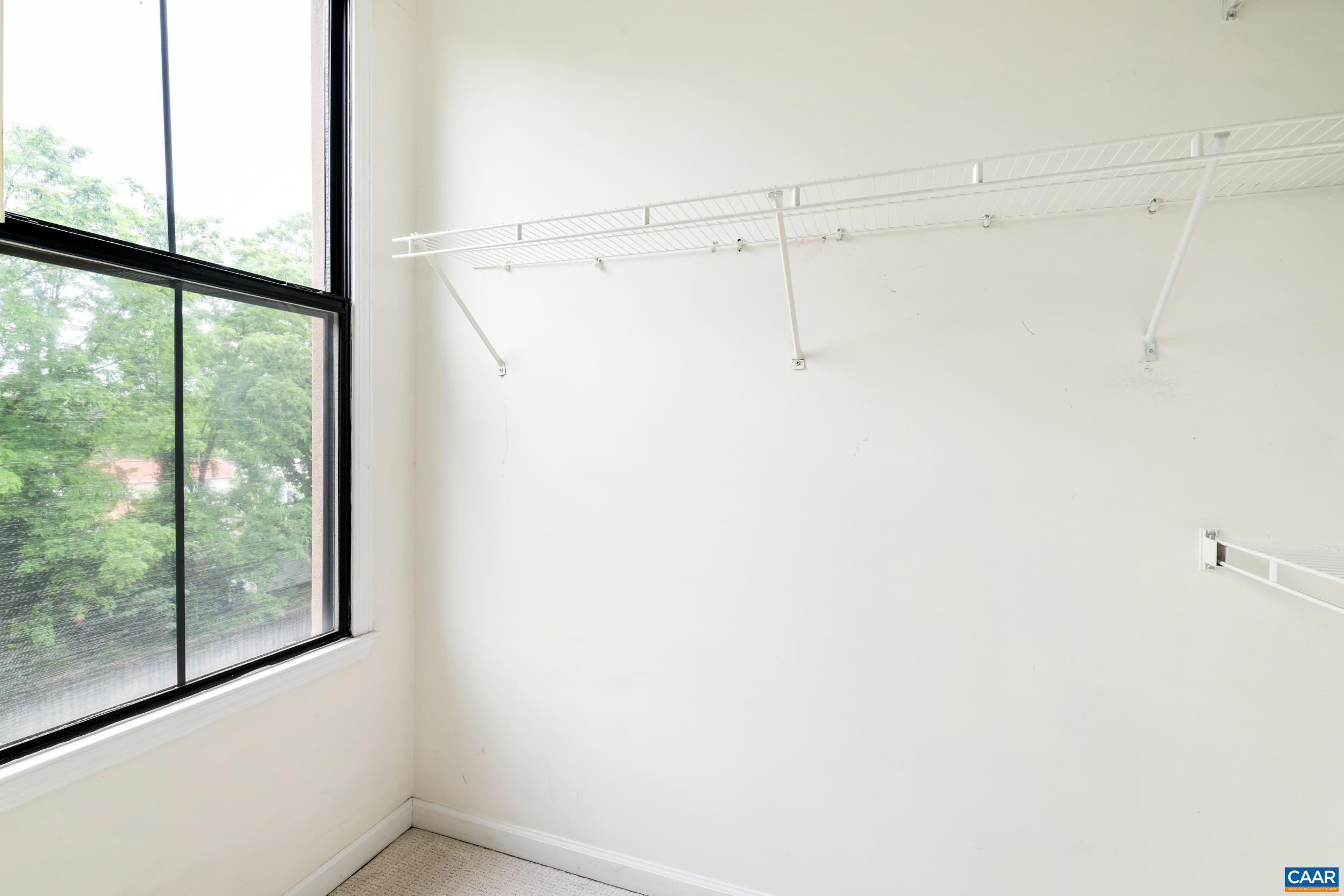 760 Walker Square, Unit 4B Charlottesville, VA 22903 - Photo 20 of 40 a view of a room with racks on the wall