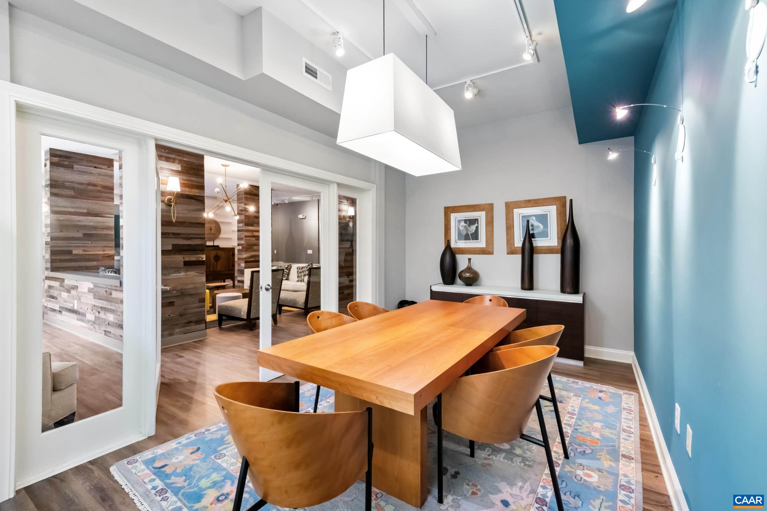 760 Walker Square, Unit 4B Charlottesville, VA 22903 - Photo 27 of 40 a dining room with wooden floor and chandelier