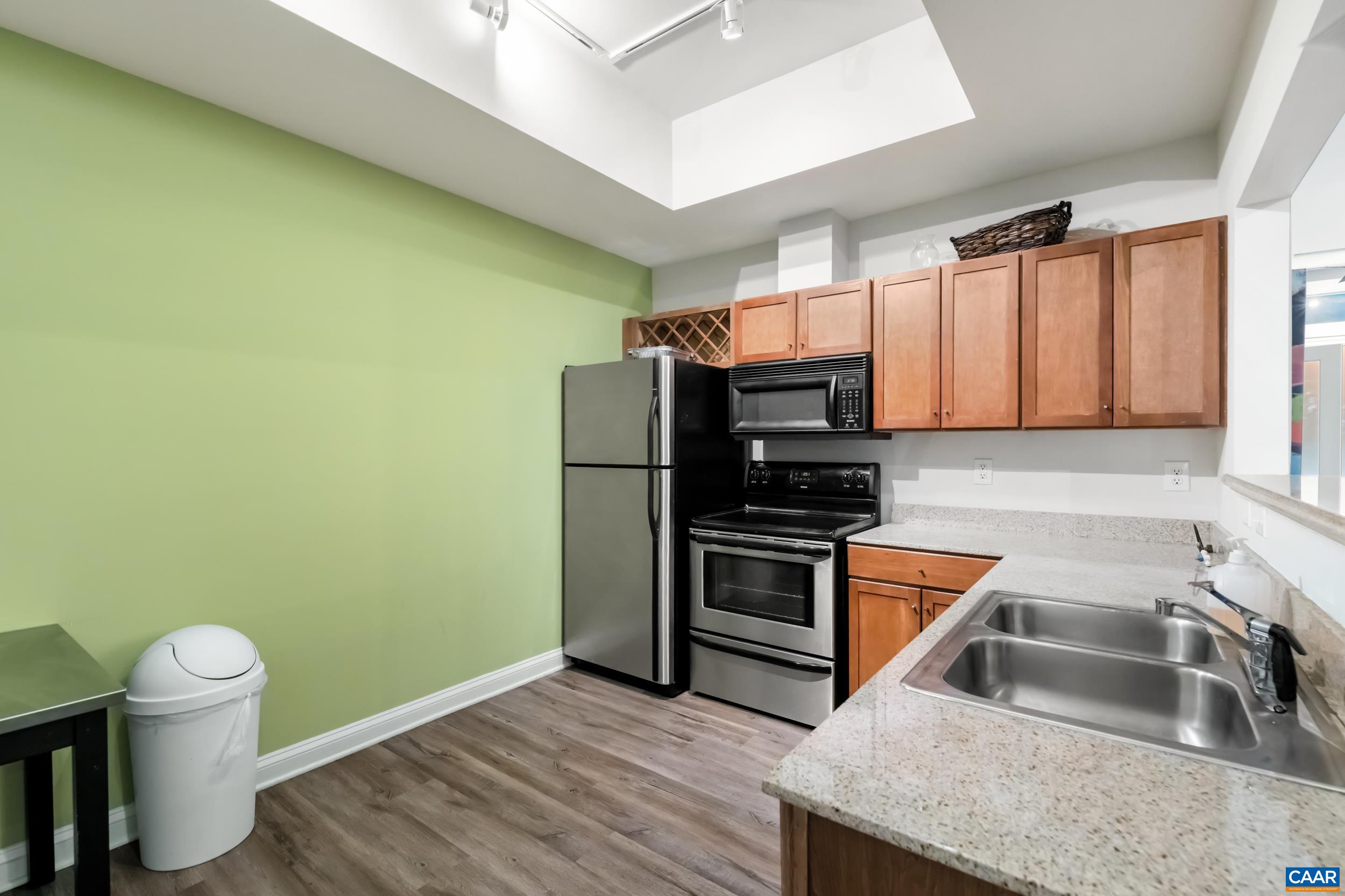 760 Walker Square, Unit 4B Charlottesville, VA 22903 - Photo 31 of 40 a kitchen with granite countertop a sink and a stove top oven