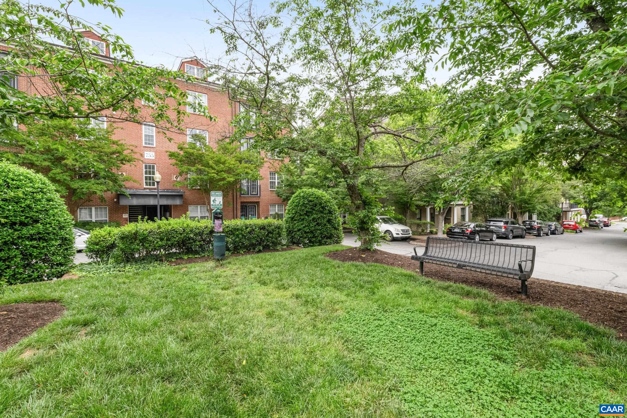 760 Walker Square, Unit 4B Charlottesville, VA 22903 - Photo 39 of 40 a view of a patio with table and chairs and a large tree