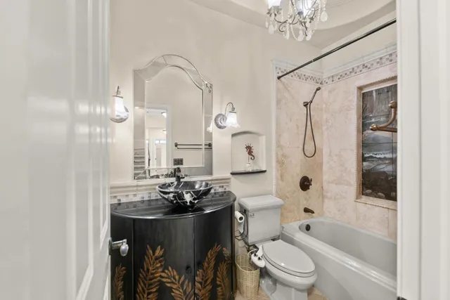 a bathroom with a granite countertop sink a toilet and a mirror
