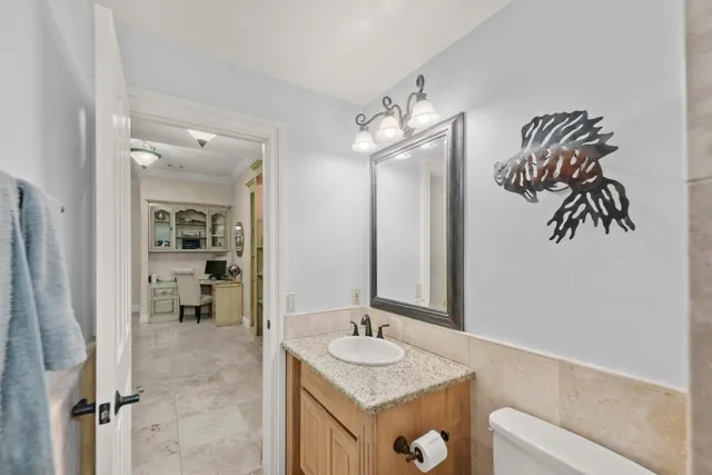 a bathroom with a granite countertop sink a mirror and shower