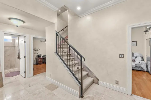 a view of a hallway with a livingroom and stairs
