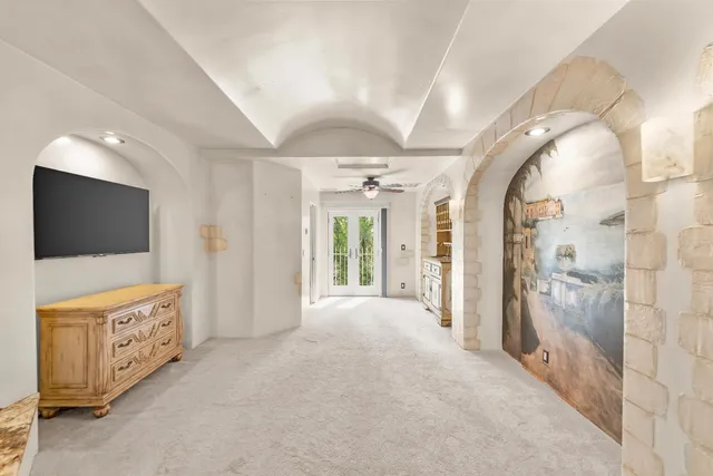 a view of a livingroom with wooden floor and a flat screen tv