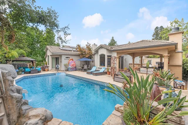 a view of a swimming pool with a patio