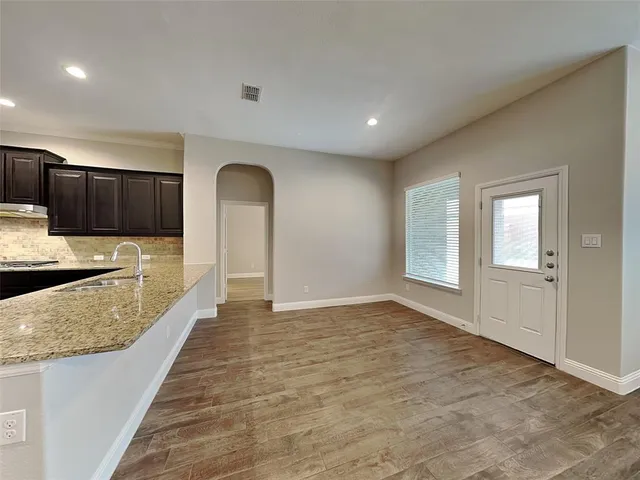 a view of a kitchen with a sink and cabinets