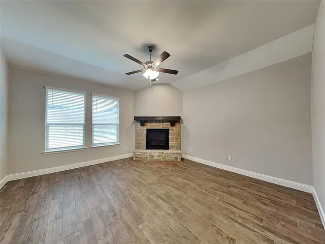 wooden floor in an empty room with a fireplace