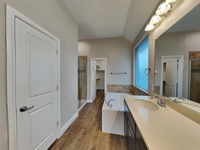 a bathroom with a sink double vanity granite tub and shower