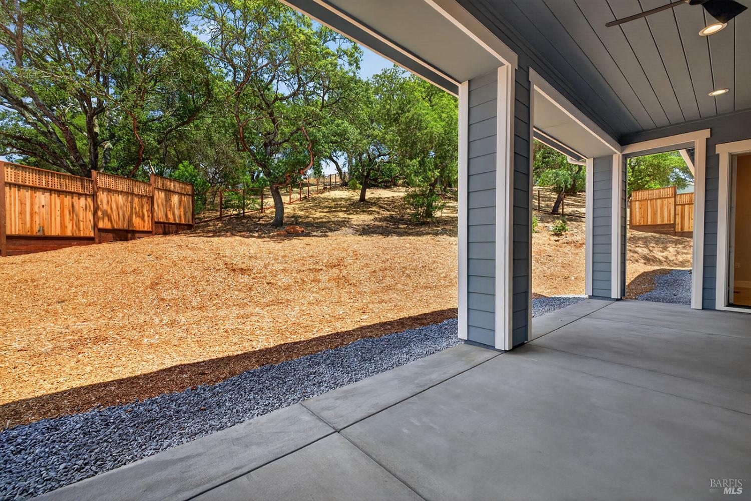 1907 Carlile Place Santa Rosa, CA 95403 - Photo 12 of 55 As we step out of the great room, we are standing under the covered loggia looking towards the oversized and private backyard. The entrance at the right rear of the photo is the exterior door from the main level primary suite.