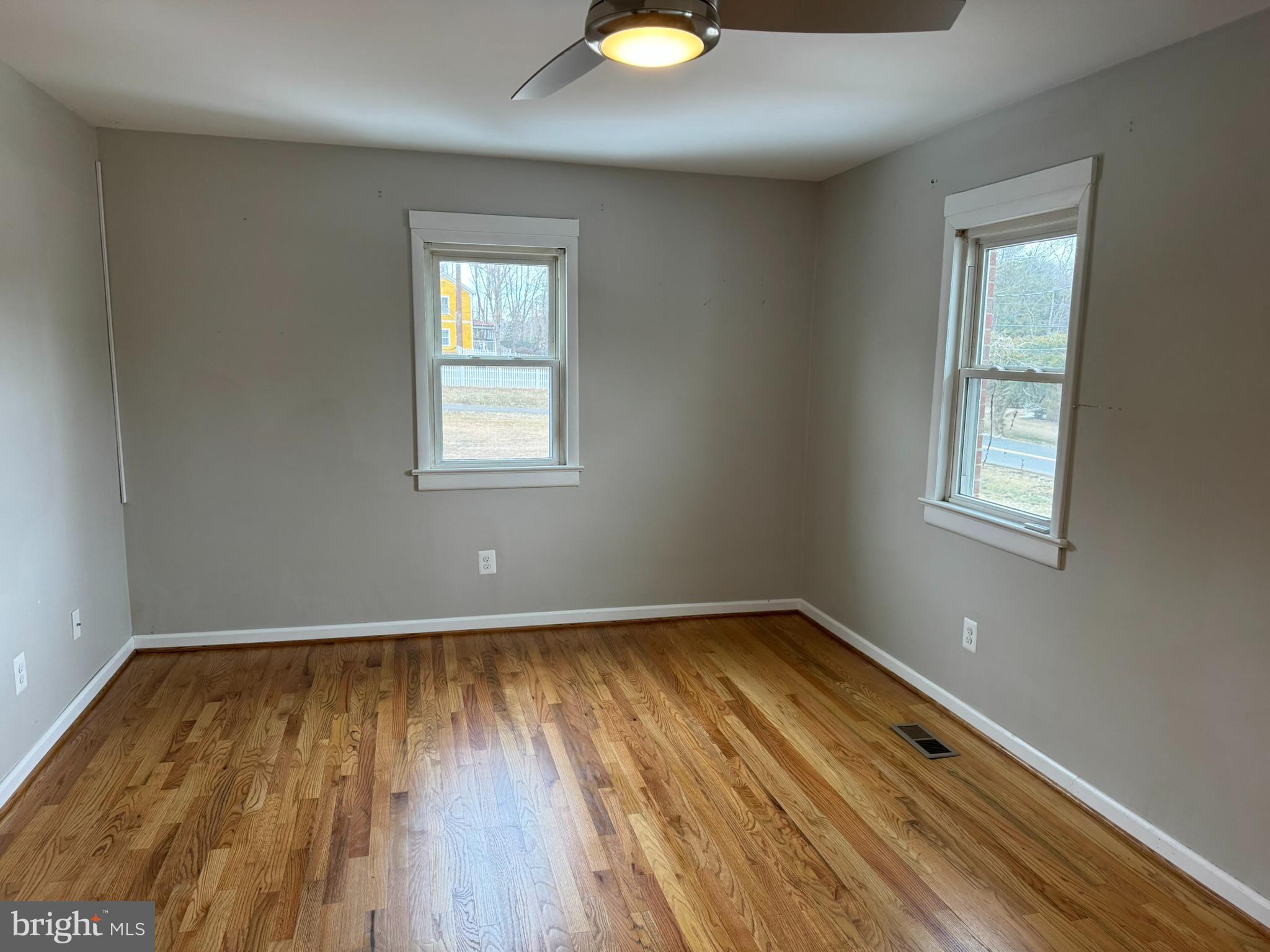 10012 Ellis Road Manassas, VA 20111 - Photo 14 of 71 a view of an empty room with wooden floor and a window