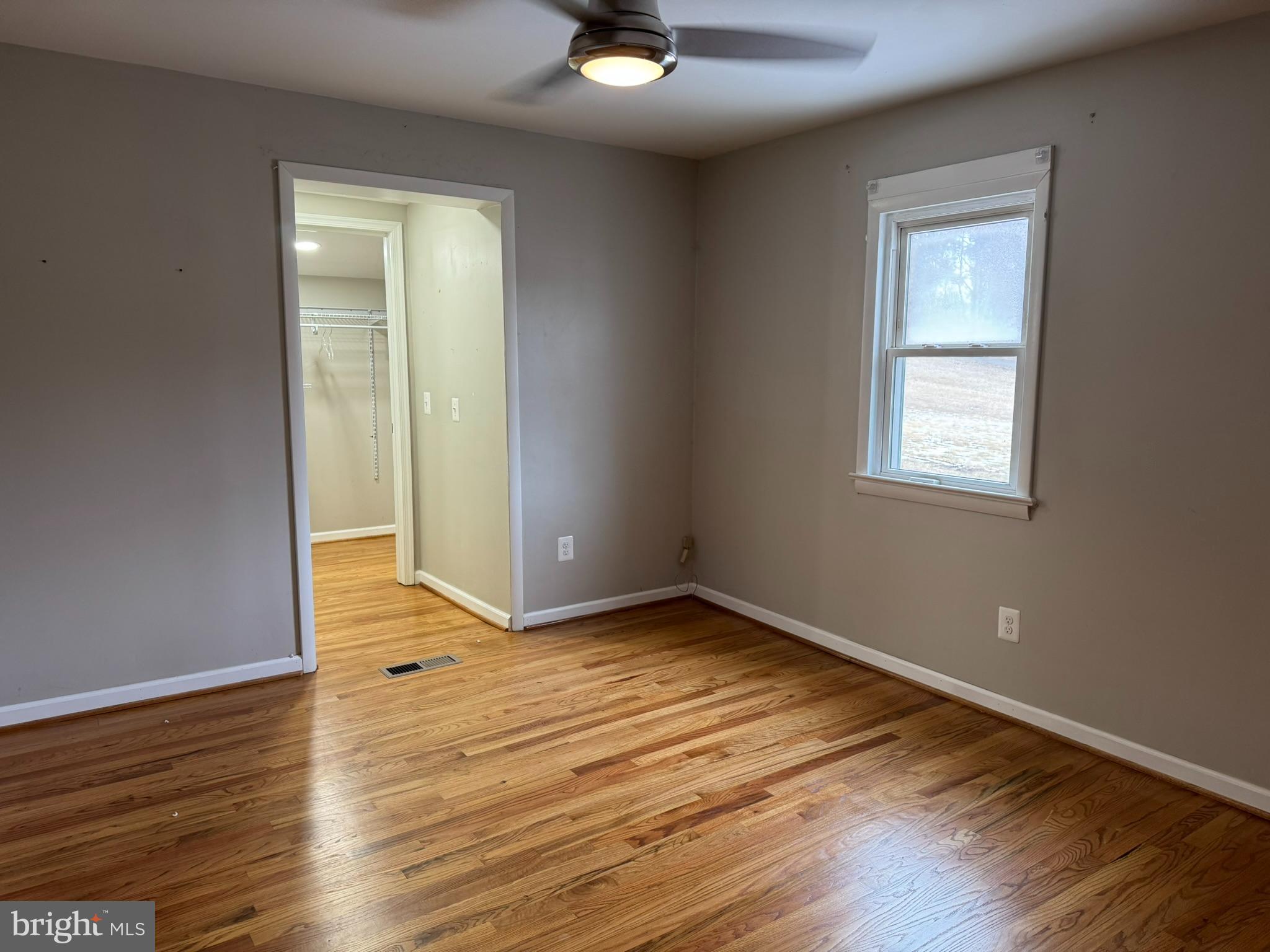 10012 Ellis Road Manassas, VA 20111 - Photo 16 of 71 a view of an empty room with wooden floor and a window